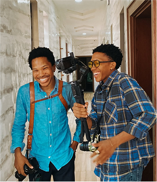 Brothers laughing and holding cameras