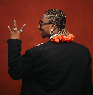 Person with braids doing peace sign
